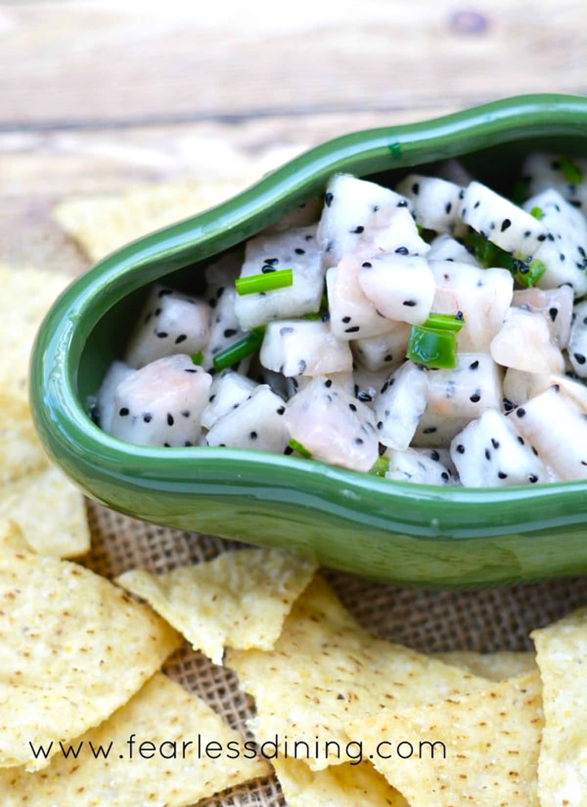 A chile pepper shaped serving dish filled with salsa.