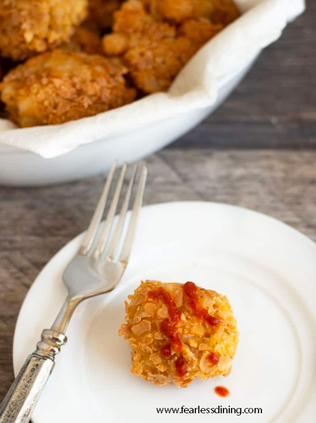 A fried mac and cheese ball on a plate.