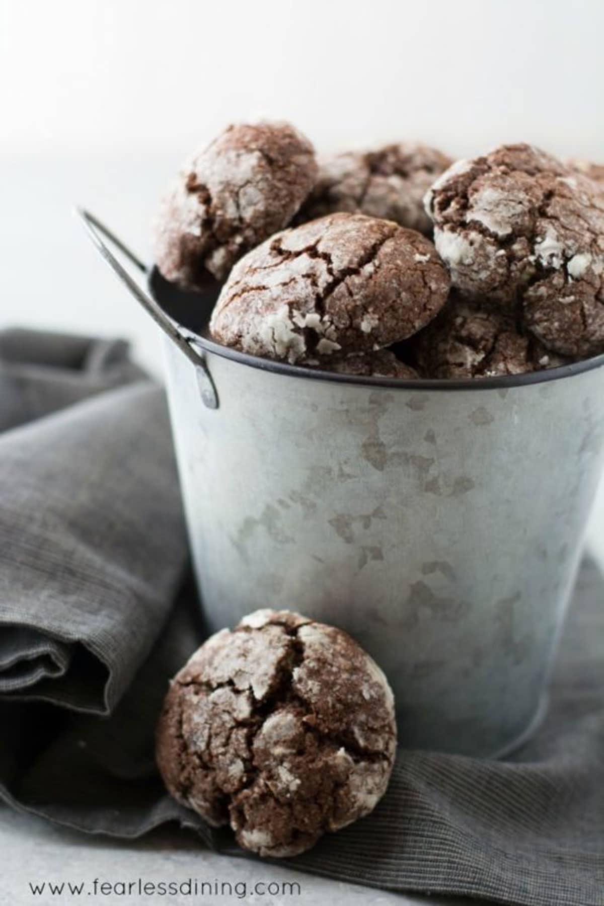 A small silver bucket filled with crinkle cookies.