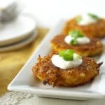 Gluten free fritters on a white rectangular serving platter.