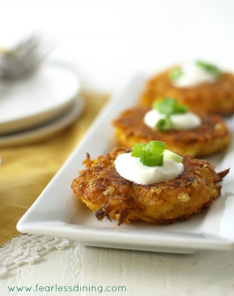 Gluten free fritters on a white rectangular serving platter.
