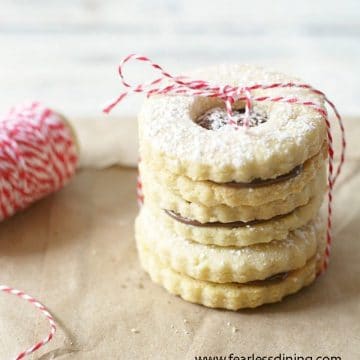 A stack of gluten free linzer cookies tied by string.