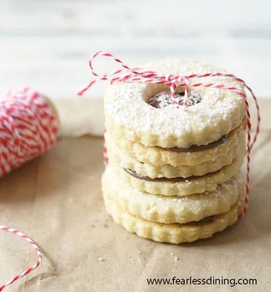 A stack of gluten free linzer cookies tied by string.