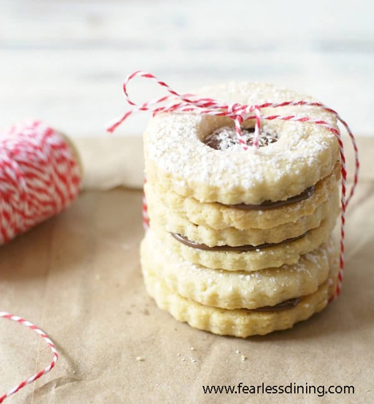 A stack of three gluten free linzer cookies.