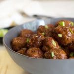 a grey bowl filled with BBQ meatballs