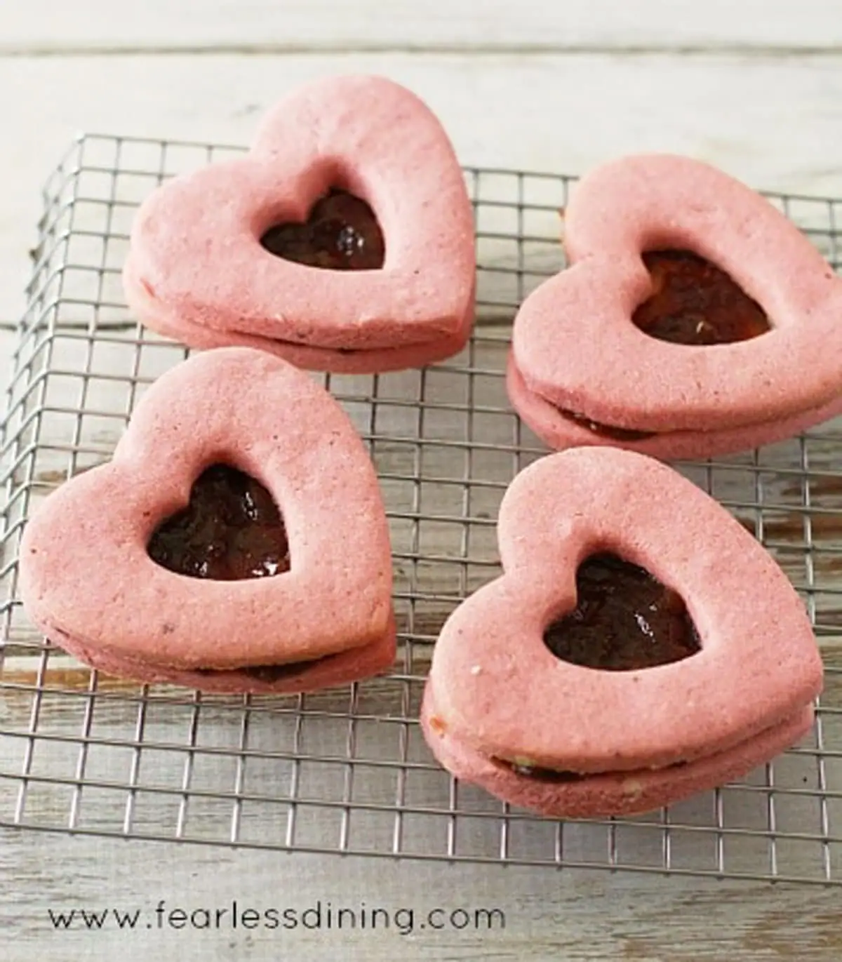 heart shaped linzer cookies on a cooling rack