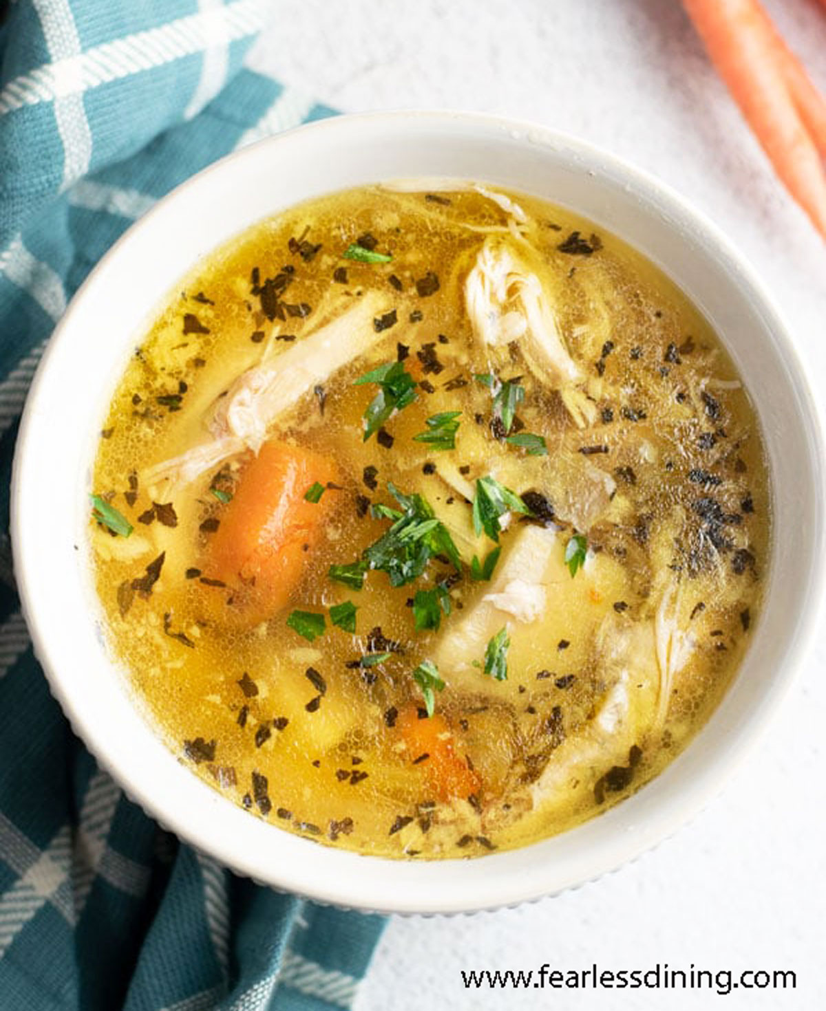 A close up of a bowl of chicken soup.