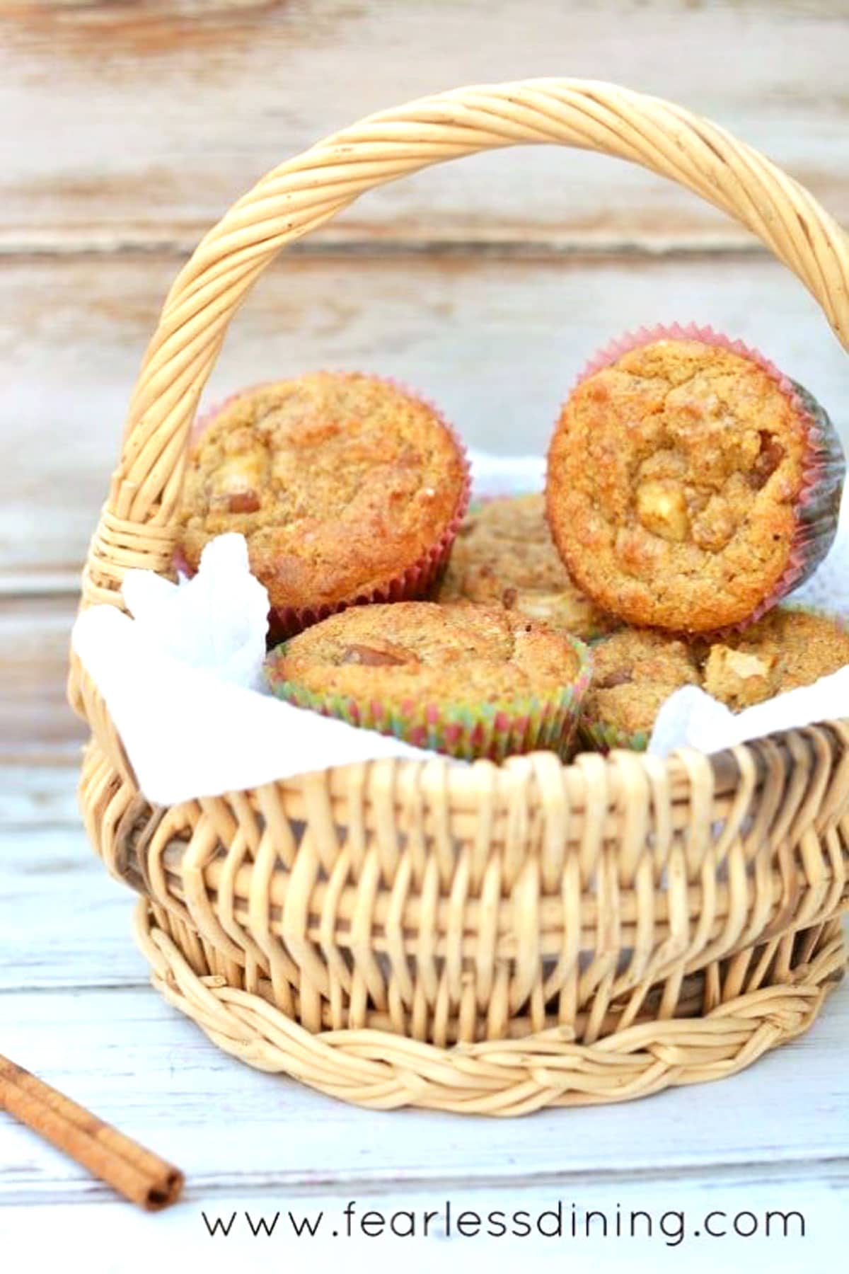 A straw basket full of pear muffins.