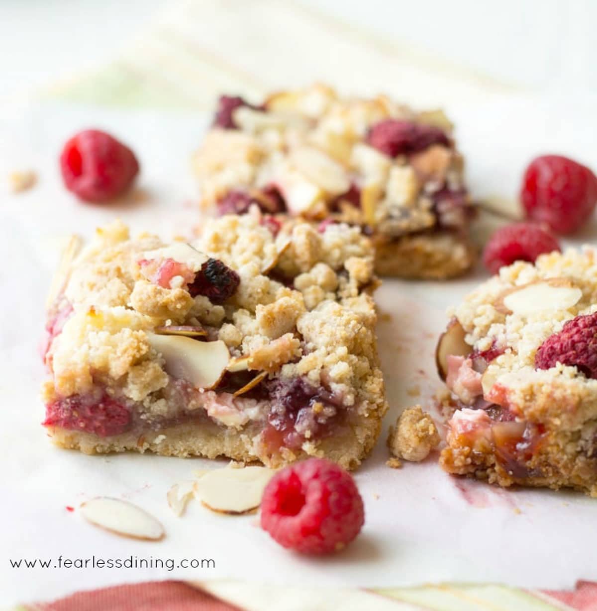 a close up of the raspberry crumble bars