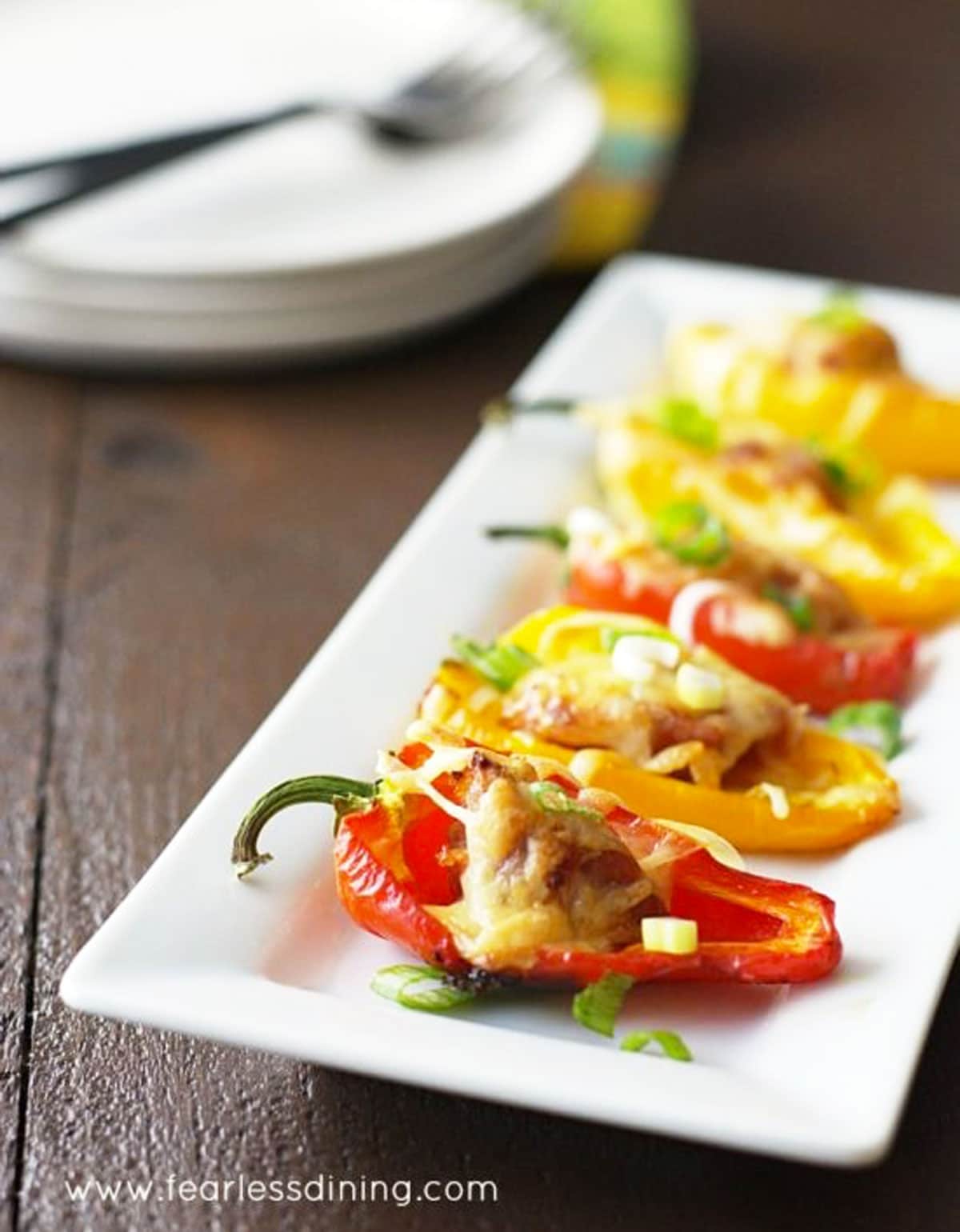 A white rectangular dish filled with stuffed peppers.