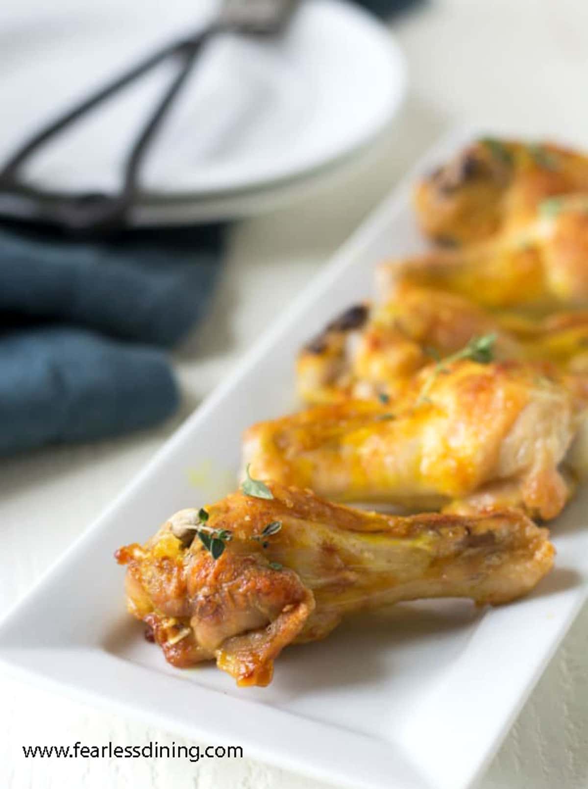 A serving dish full of the chicken wings.