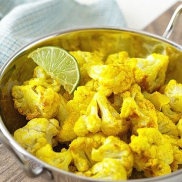 A large silver serving dish filled with roasted cauliflower.