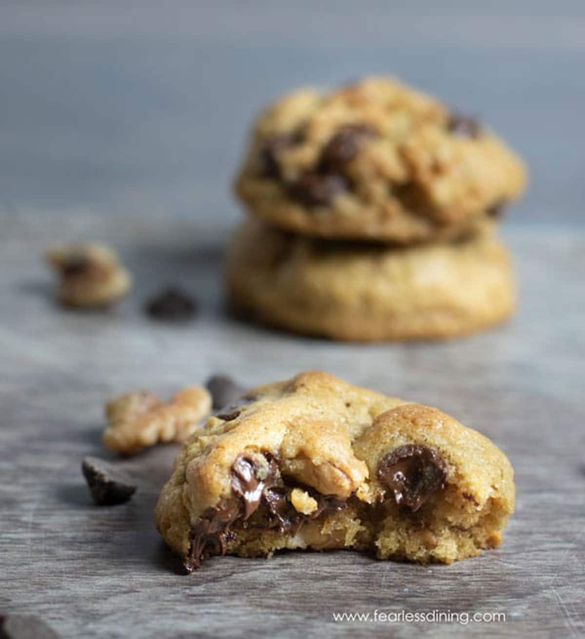 A chocolate chip cookie with a bite missing.