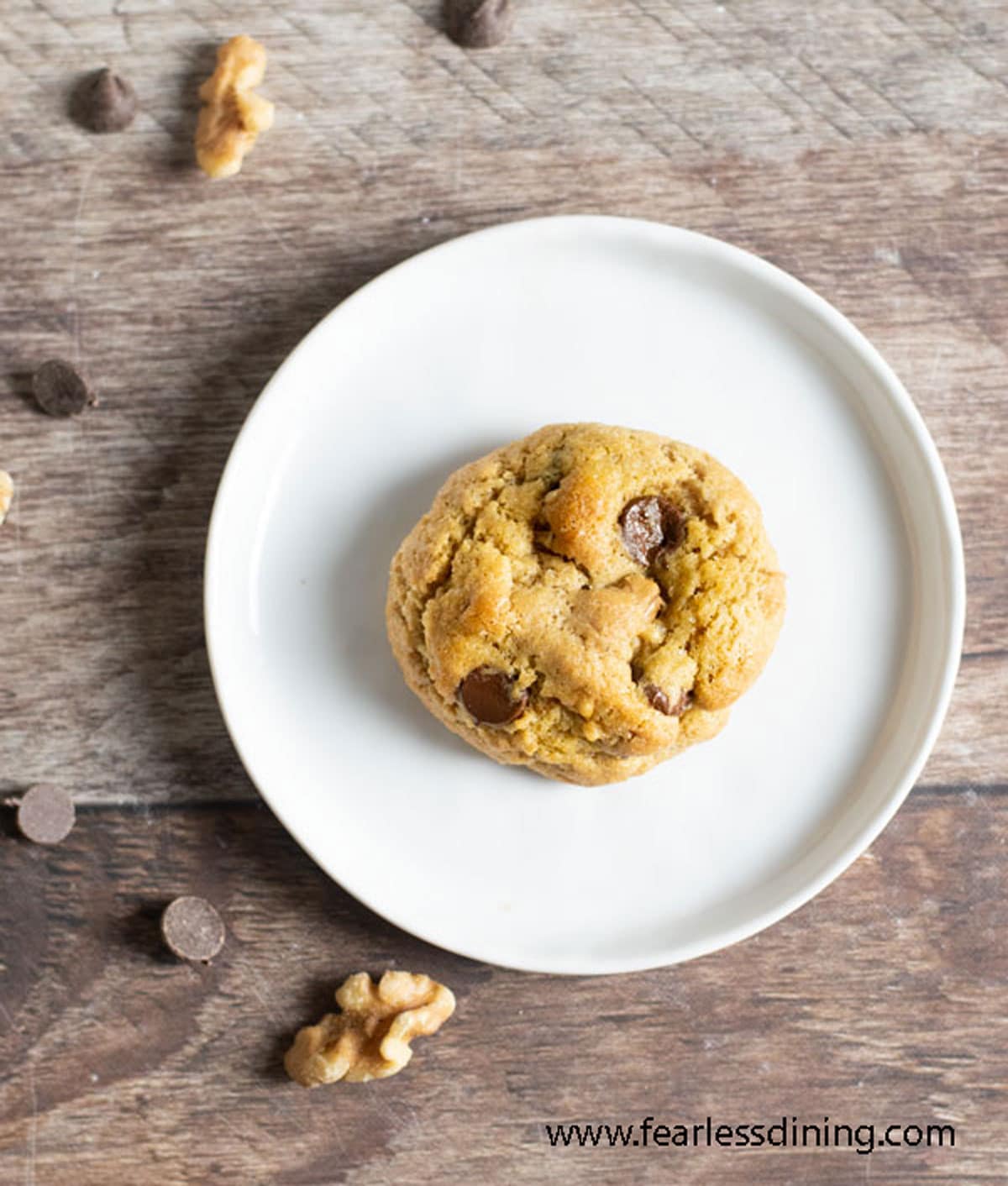 A chocolate chip cookie on a plate.