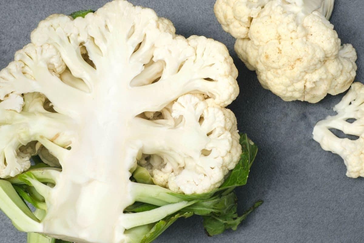 Chopped cauliflower on a cutting board.