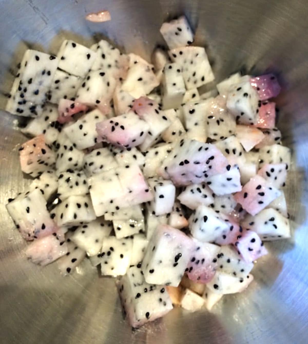 A bowl of chopped dragon fruit.