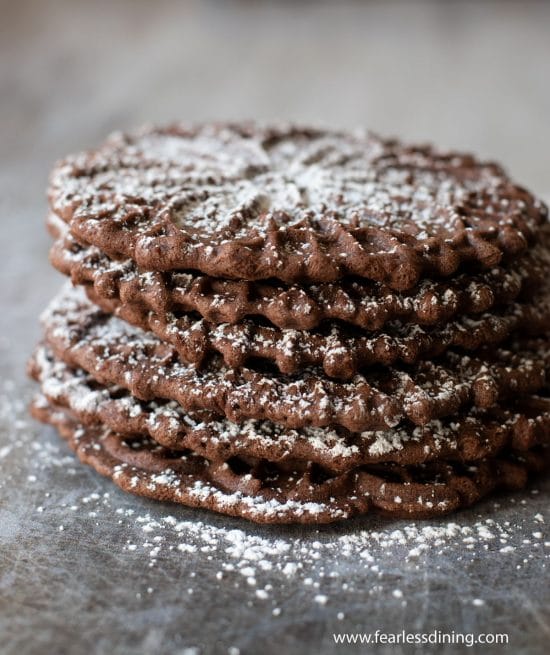 A stack of five chocolate pizzelle cookies.