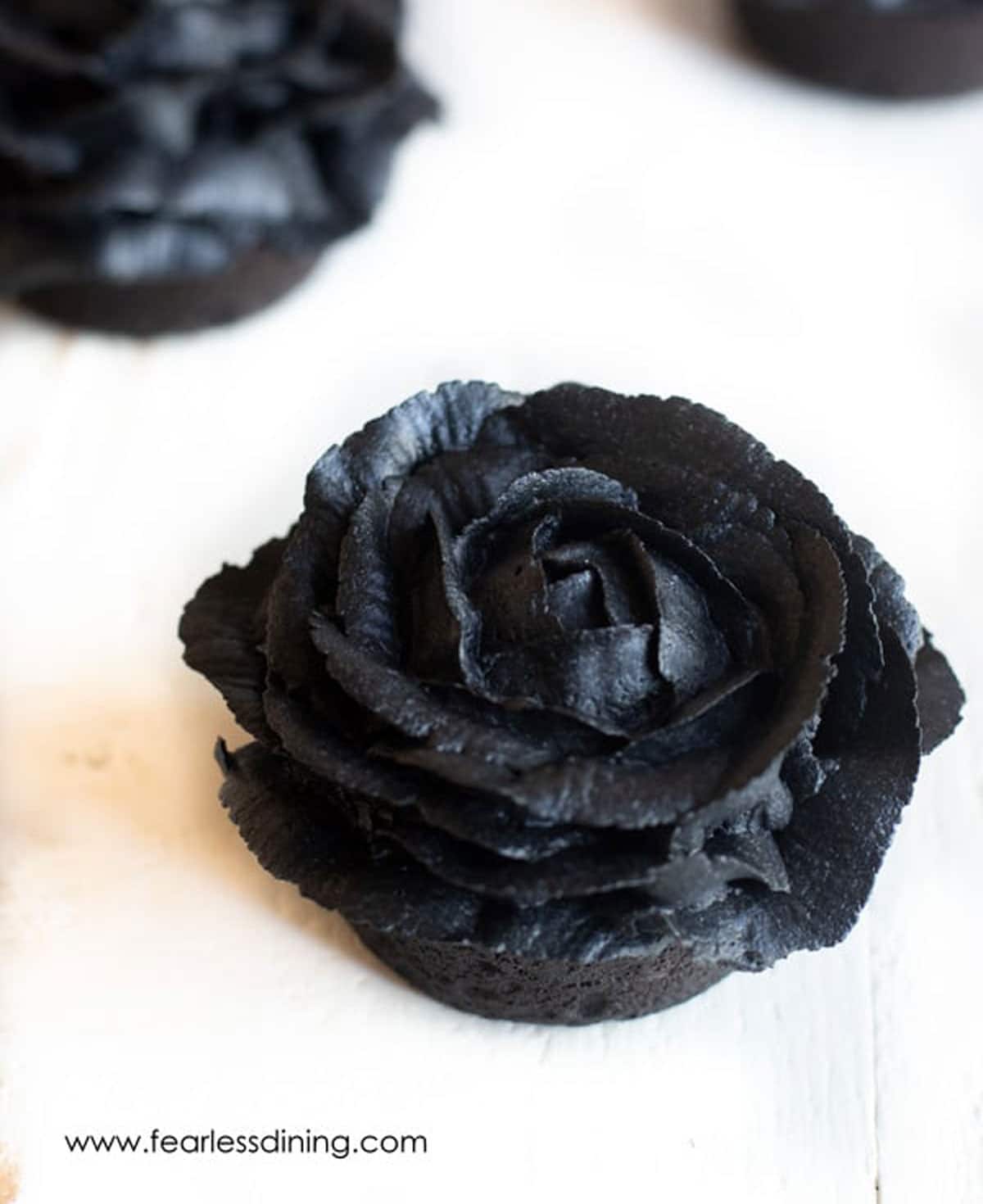 Black cupcakes frosted to look like roses.