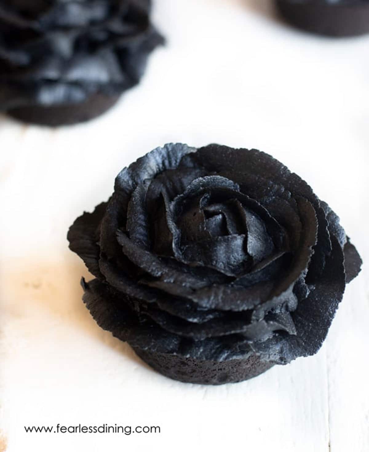 Gluten free black cupcakes frosted as black roses.