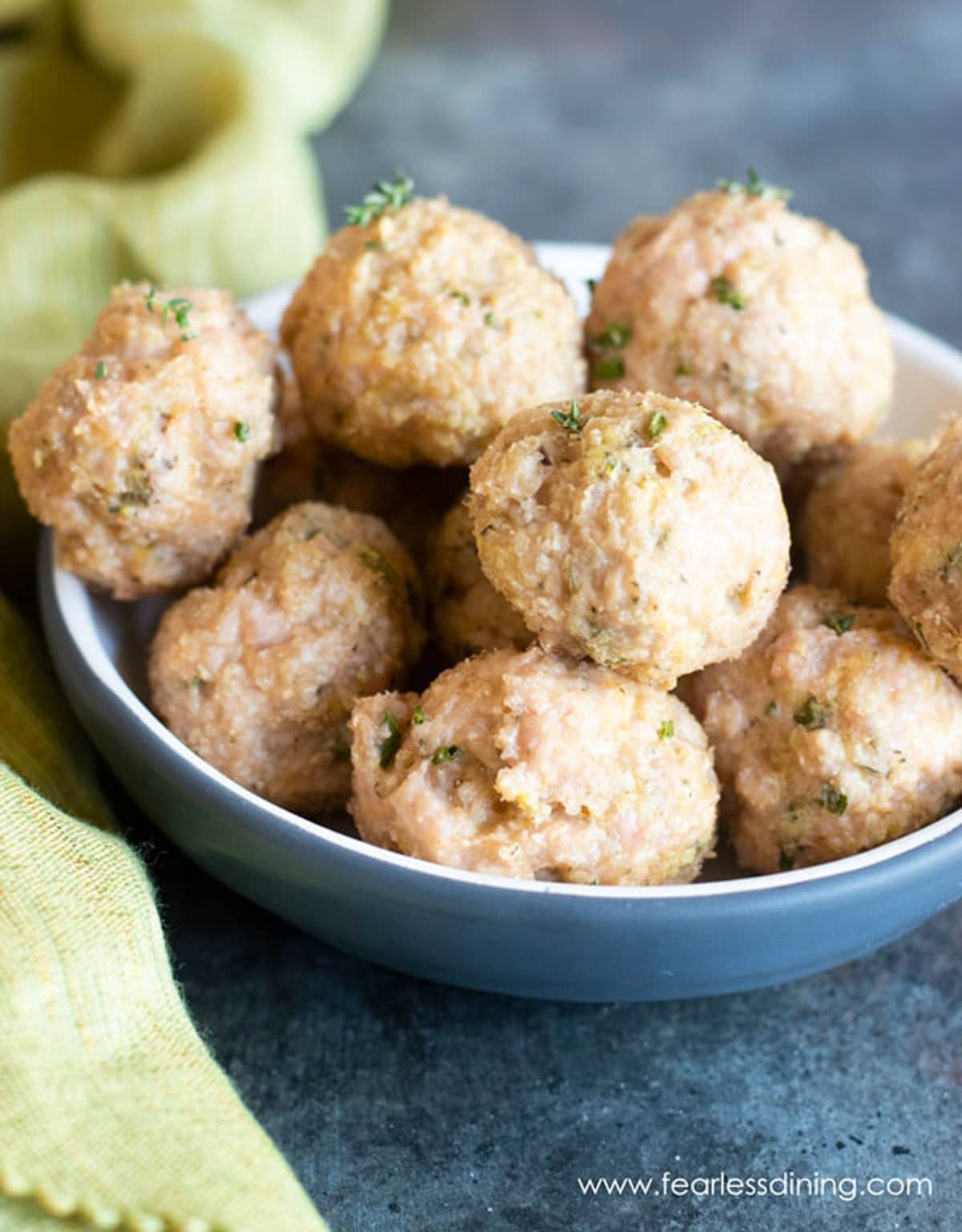 A bowl full of air fried chicken meatballs.