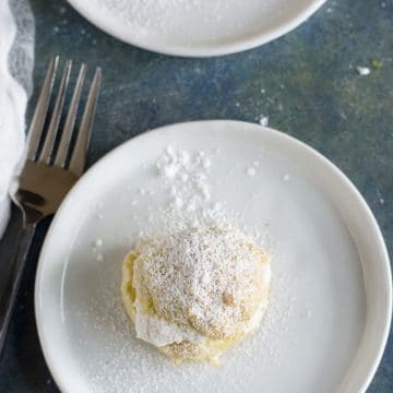 The top view of a glute free cream puff on a plate.