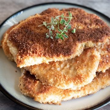 A plate filled with gluten free schnitzel.