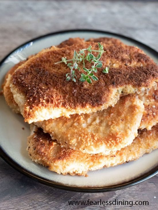 A plate filled with gluten free schnitzel.