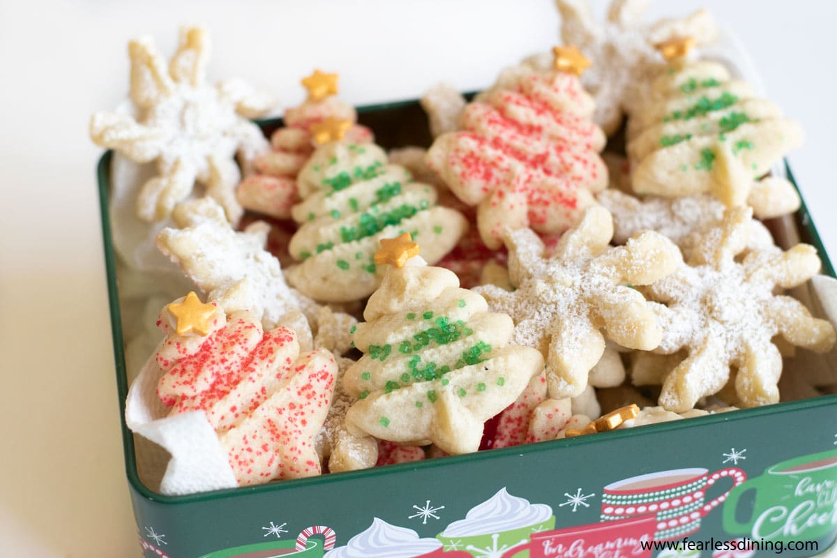 A green holiday tin full of spritz cookies.