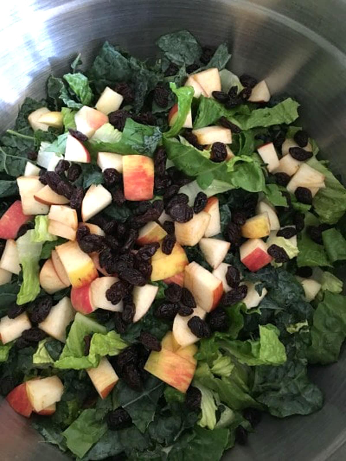 The kale salad ingredients in a bowl.