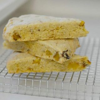 Three gluten free cornmeal scones stacked on the counter.