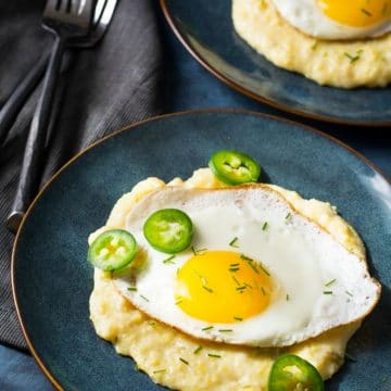 Cheese grits with a sunnyside up fried egg on top.