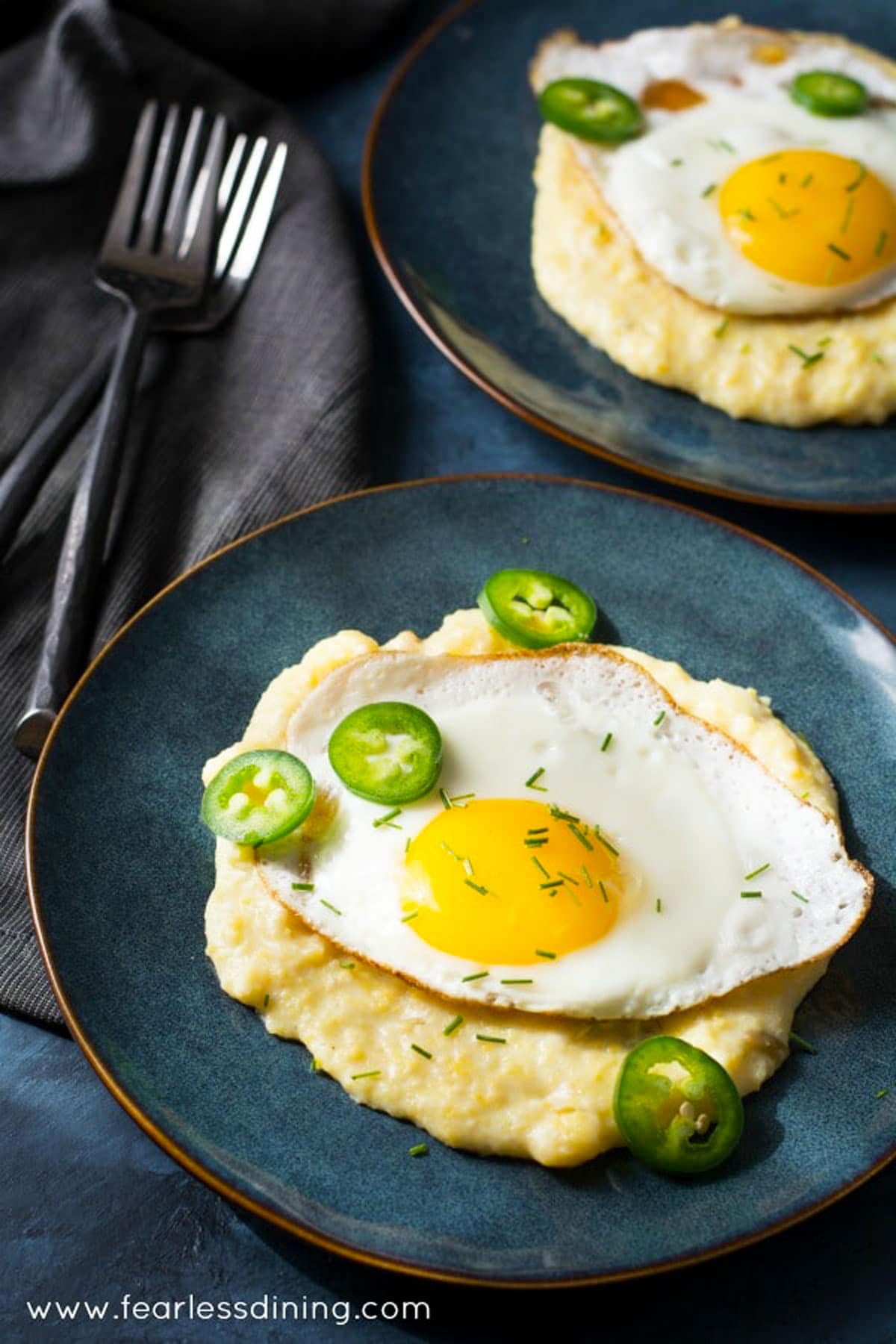Cheese grits with a sunny side up fried egg on top.
