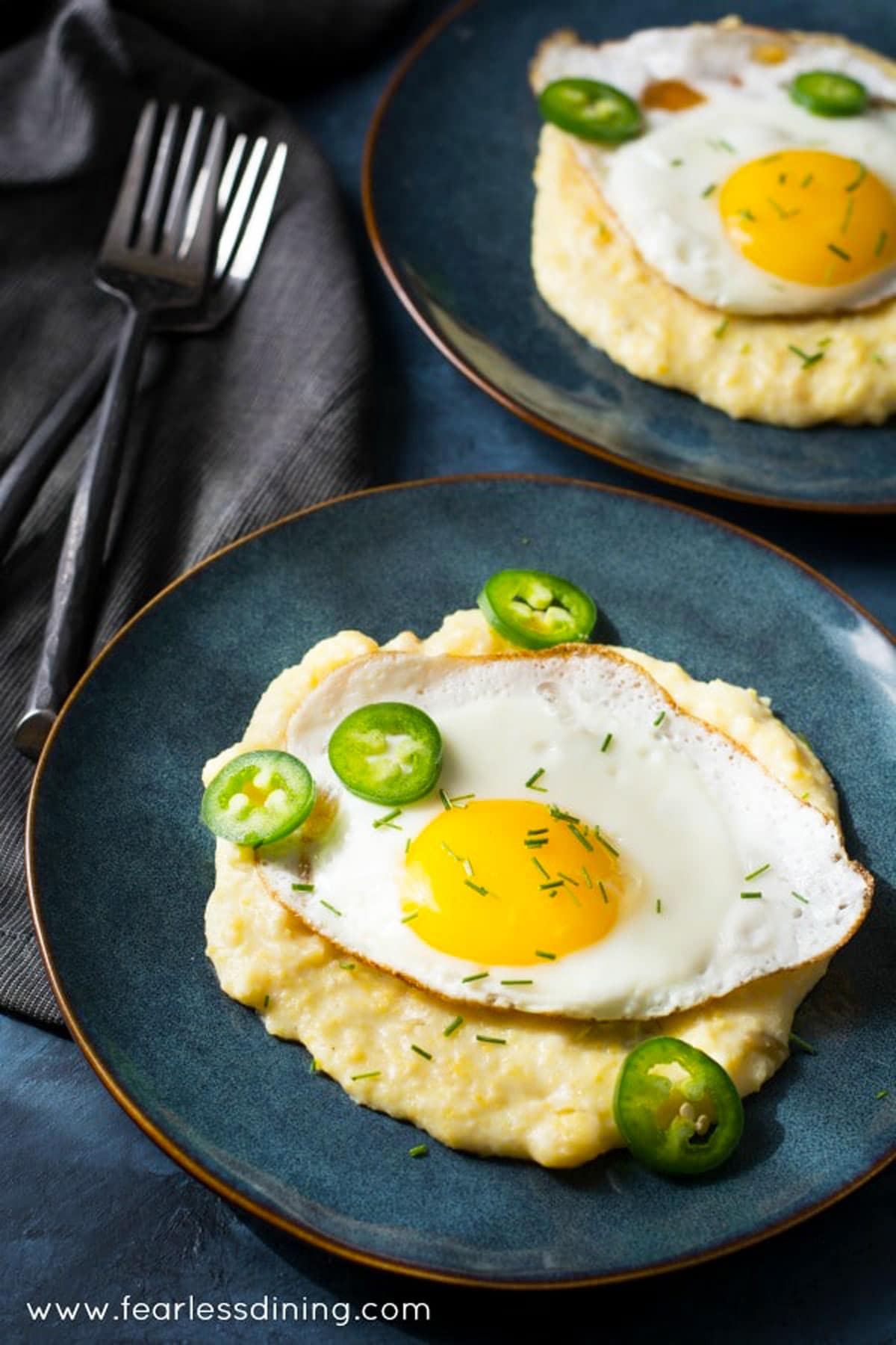 Cheese grits with a sunnyside up fried egg on top.