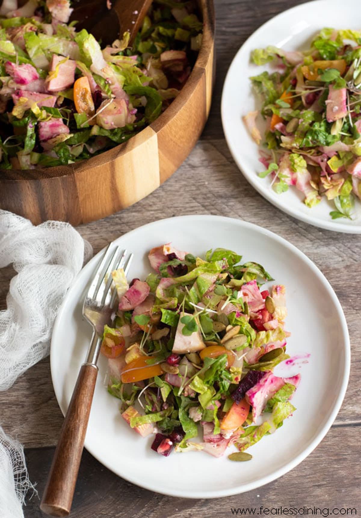 Servings of the chopped salad on white plates.