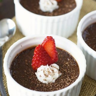 a close up of the chocolate custard in white ramekins