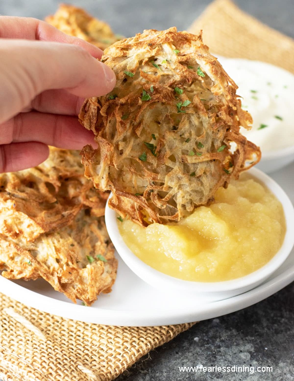 Dipping a latke into applesauce.