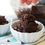Sprinkling chocolate chips over the edible cookie dough.