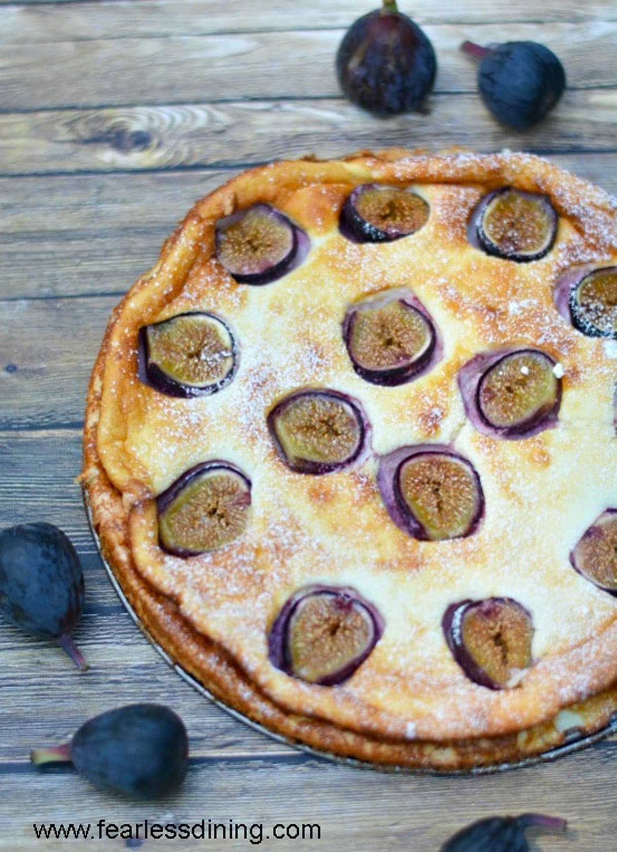 The top view of a fig cake on a wooden table.