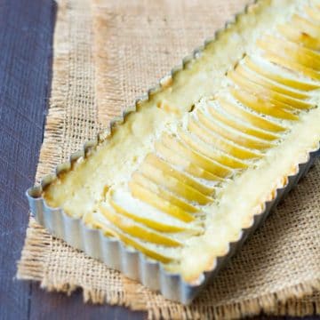 A baked apple tart in the tart pan.