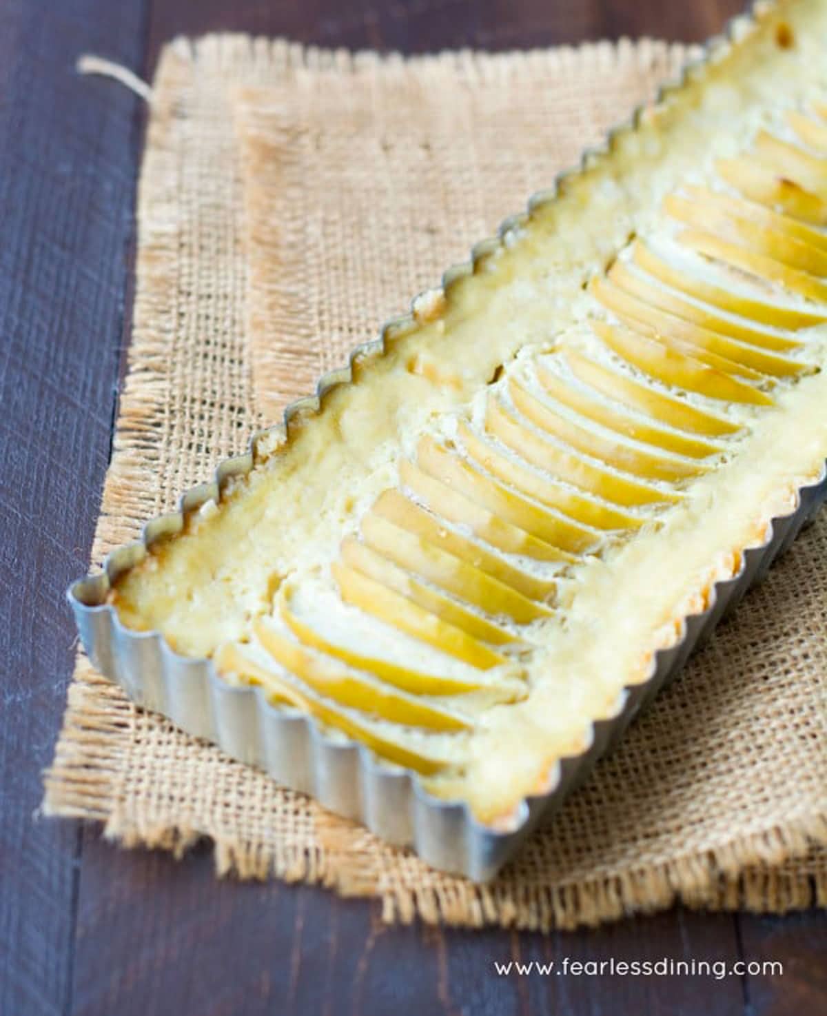 A baked apple tart in the tart pan.