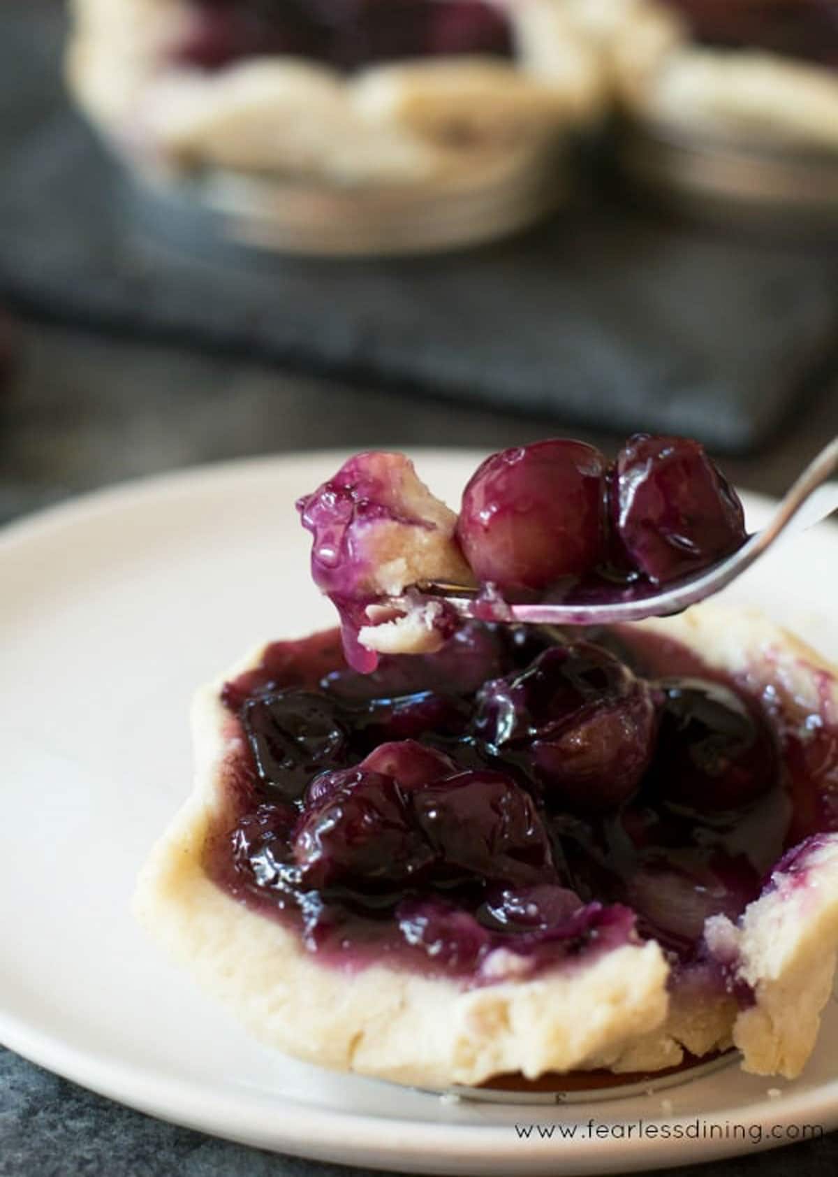 A fork full of grape pie filling.