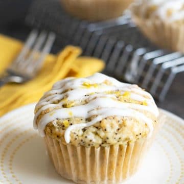 A lemon poppy seed muffin on a plate.