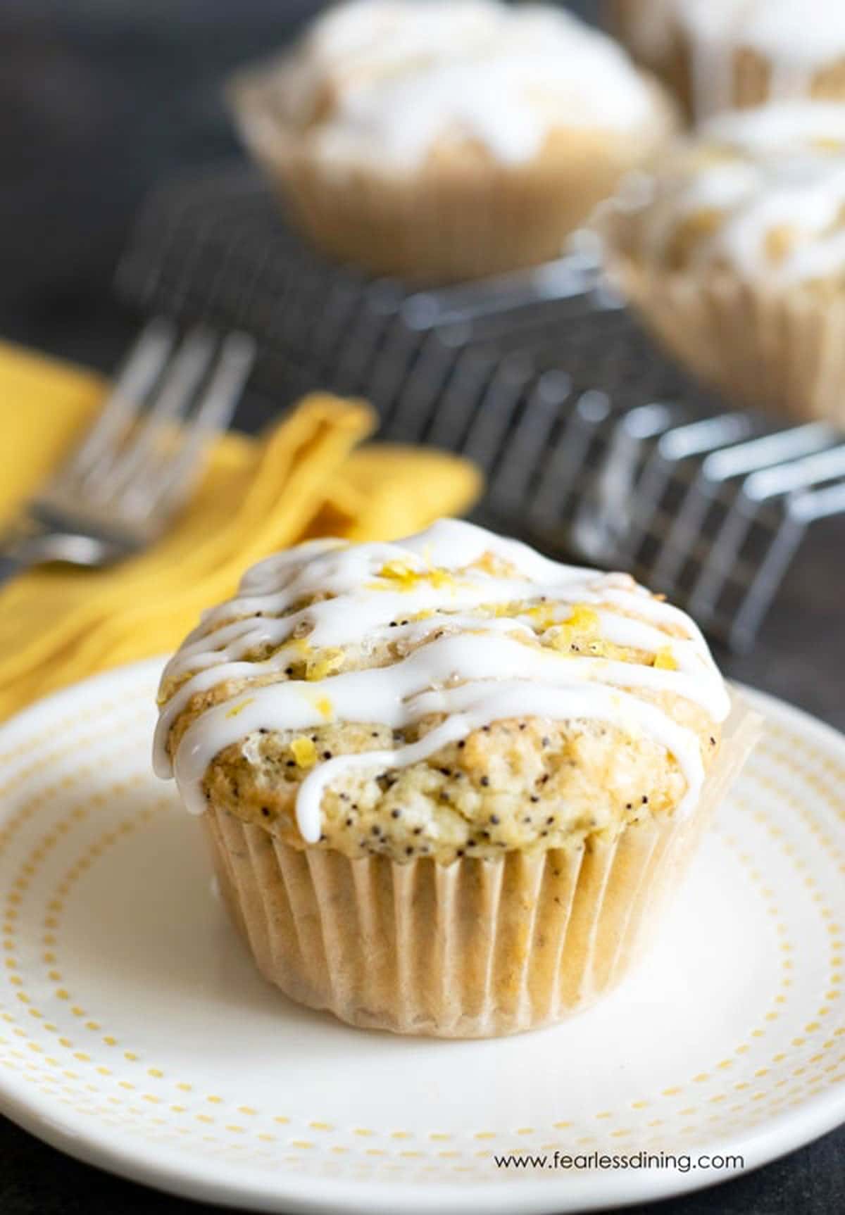 A lemon poppy seed muffin on a plate.