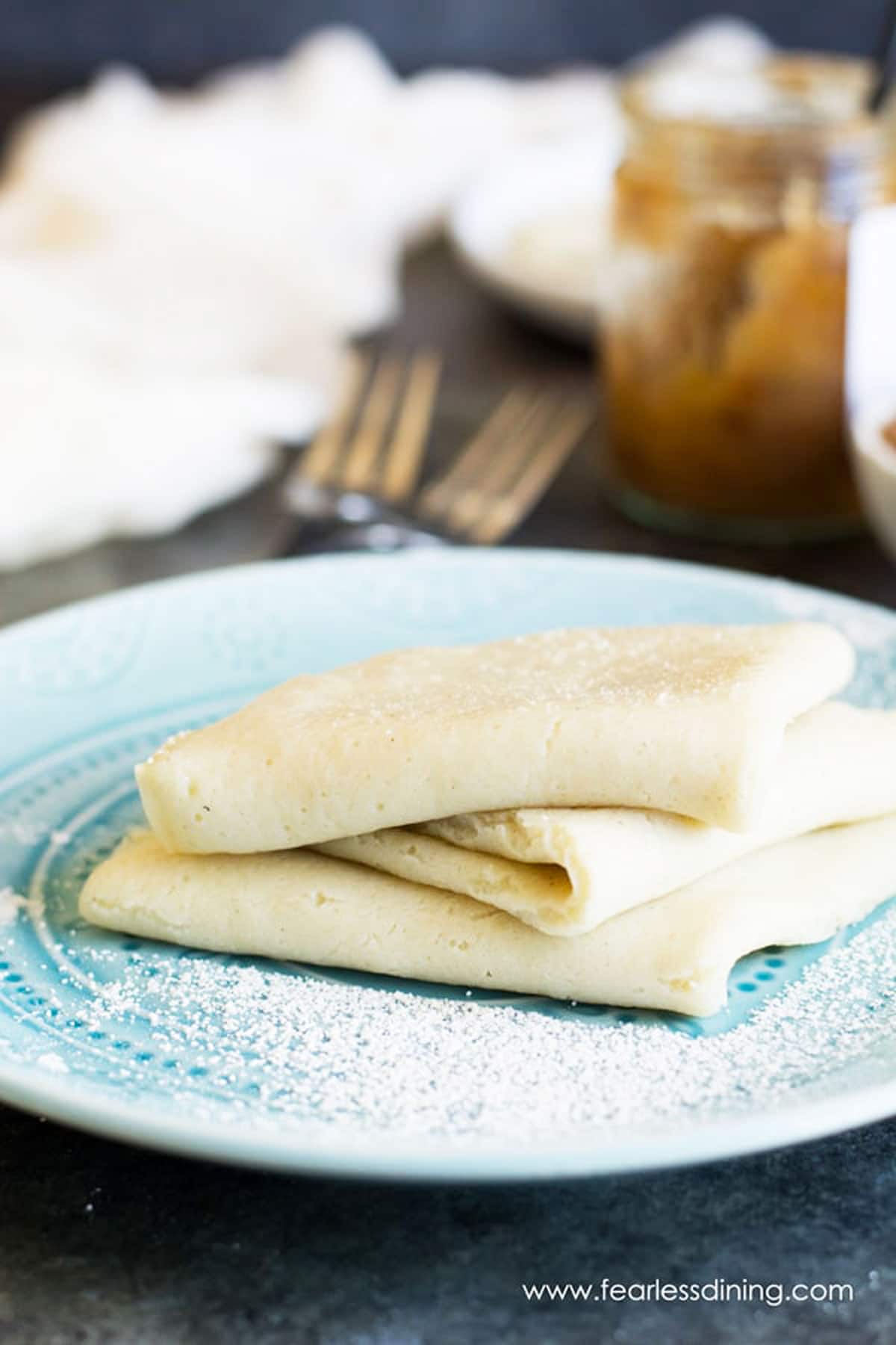 a stack of folded crepes on a plate