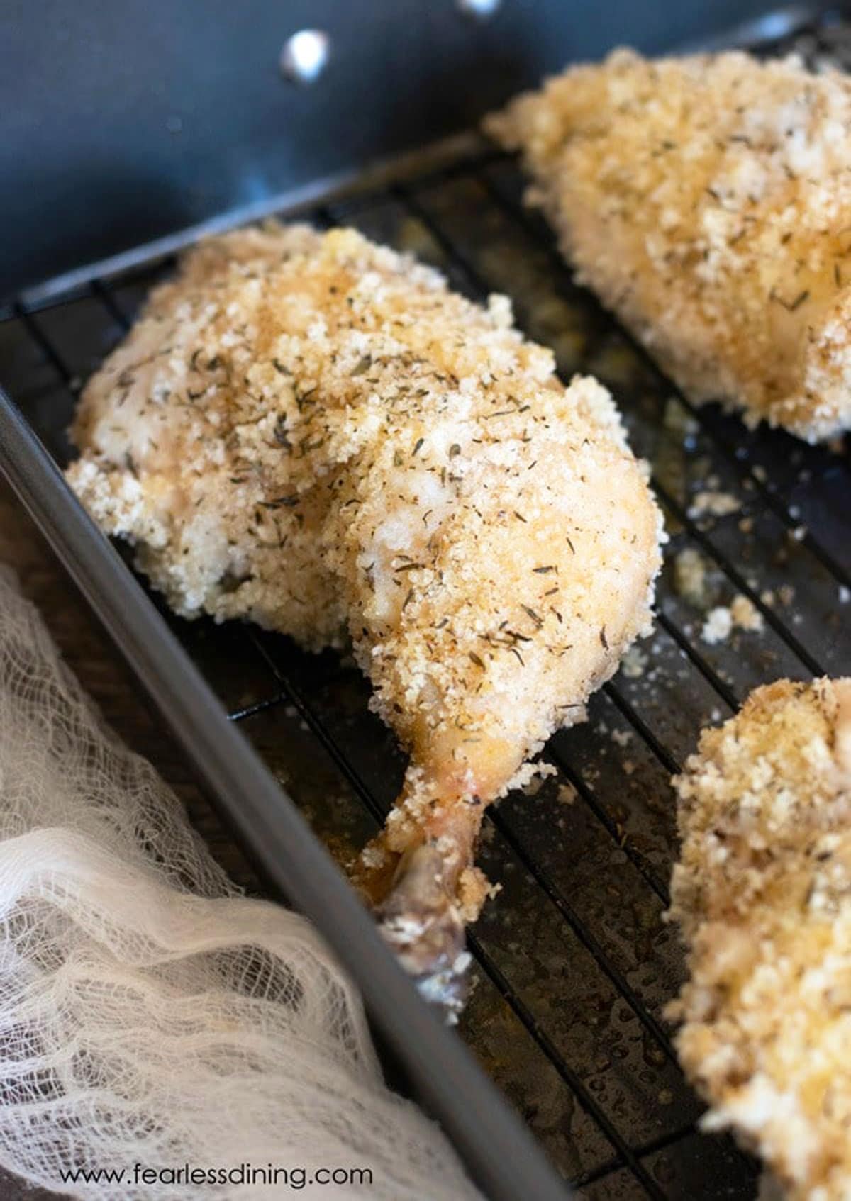 A close up of the oven fried chicken in the baking pan.