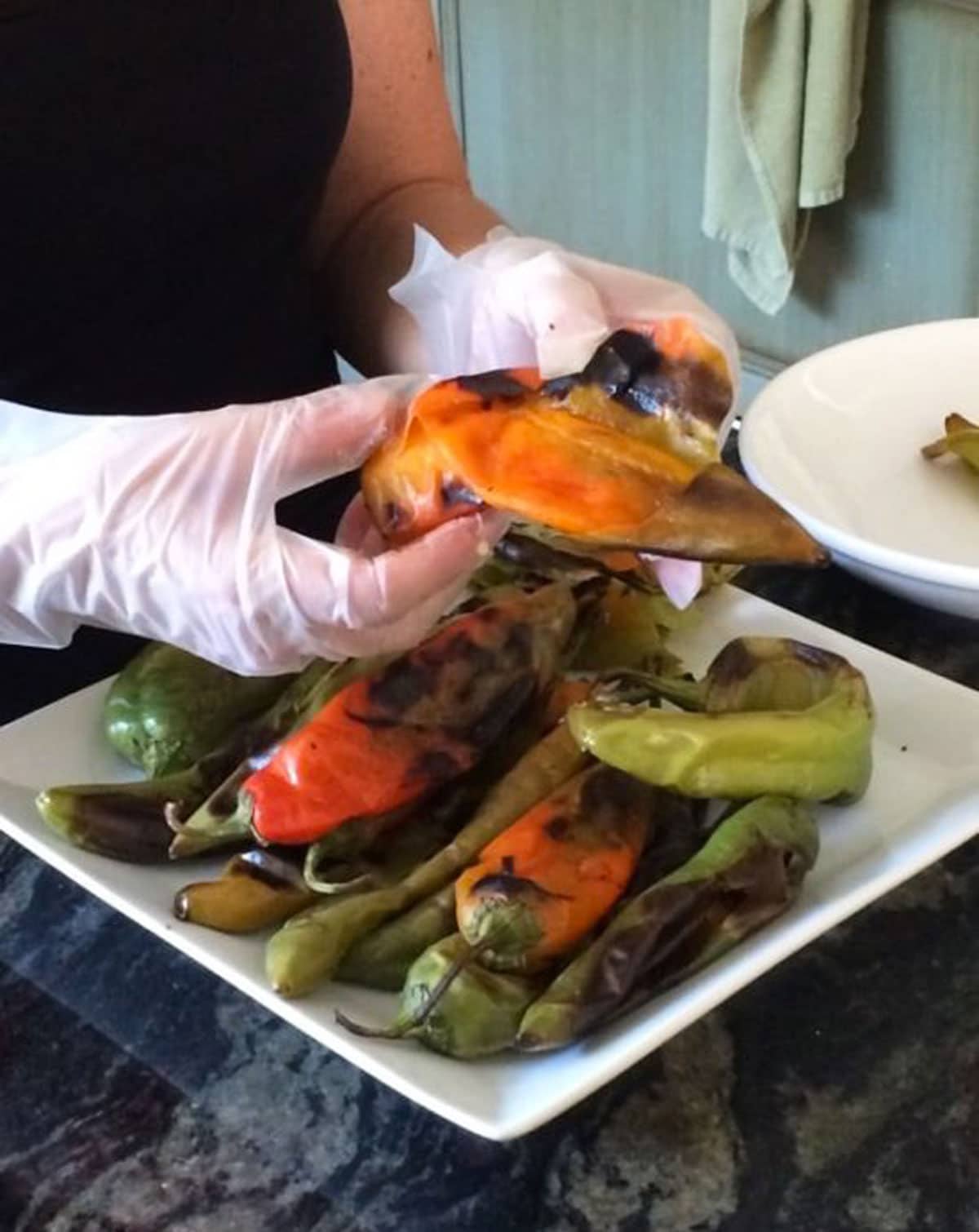 Peeling blistered hatch green chiles.