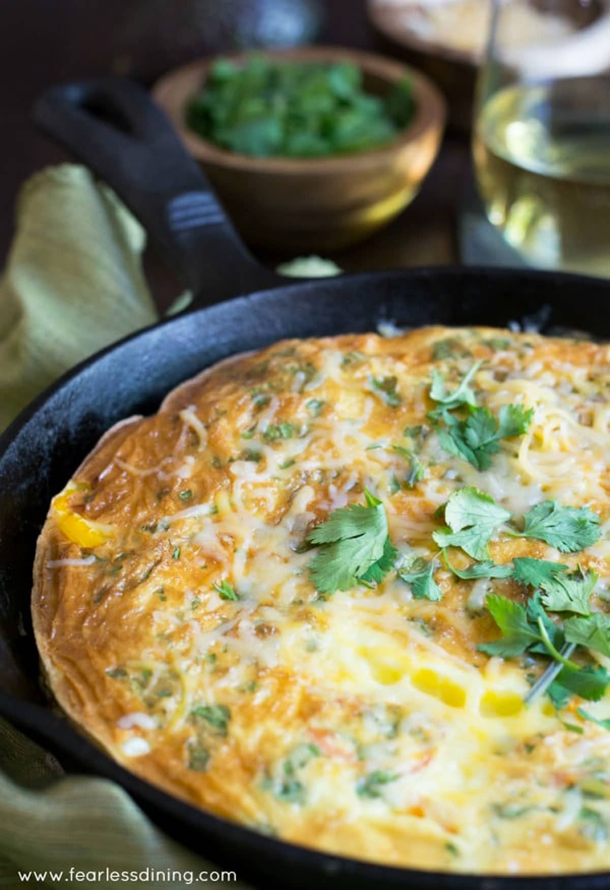 A cooked frittata in a cast iron skillet.
