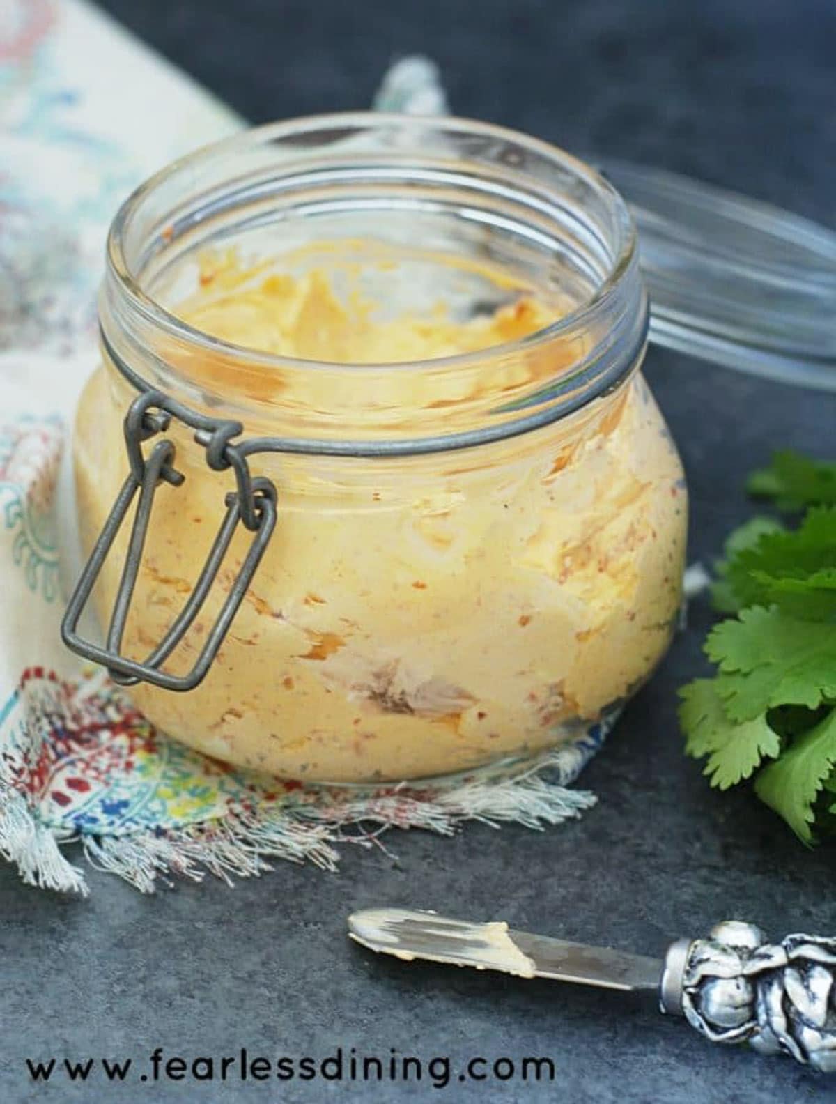 Red pepper cream cheese ready to serve in a container.