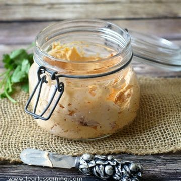A small mason jar filled with roasted red pepper cream cheese spread.