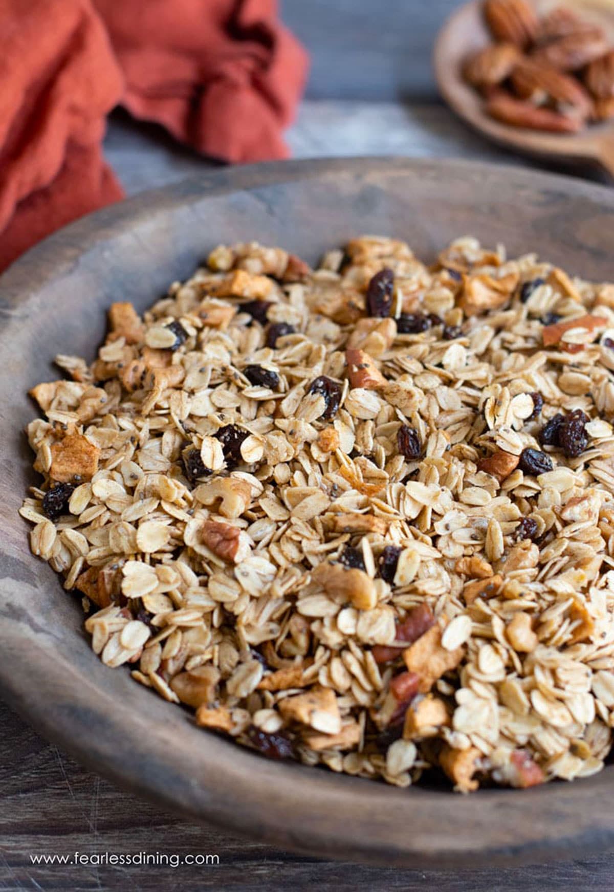 A wooden bowl full of granola.